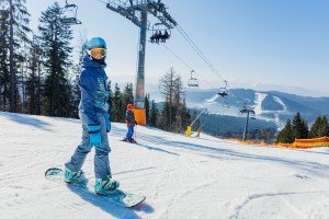 Girl snowboarding down a slope